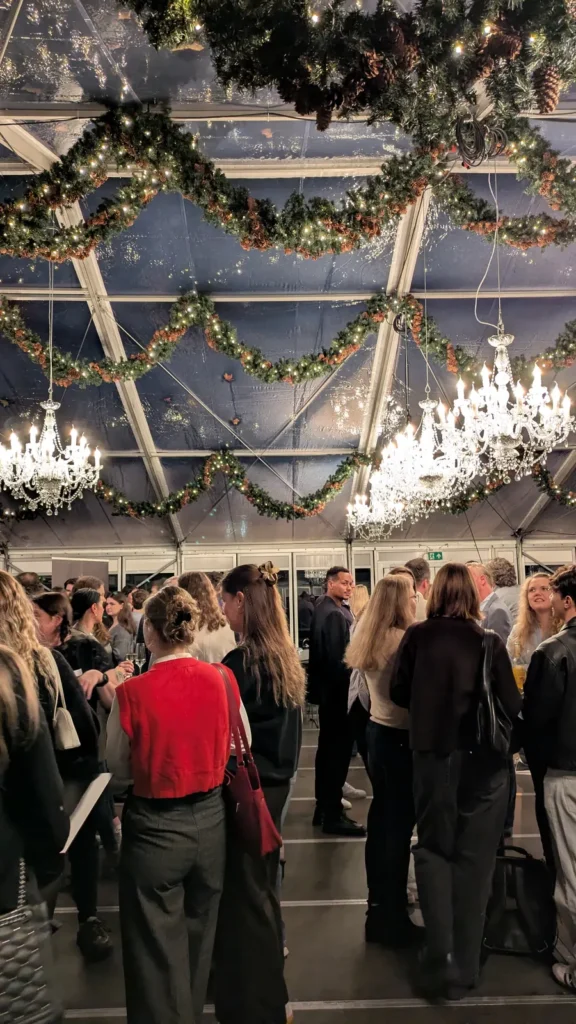 Gäste beim Get-together 2025 im Glashaus der Alten Reederei unter Kronleuchtern
